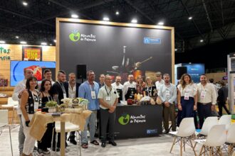 Varias personas posan para la foto en el stand de Alimentos de Palencia